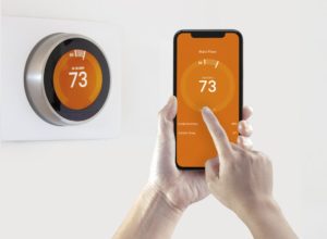 Temperature On Orange Smart Thermostat Controlled By Smart Phone App